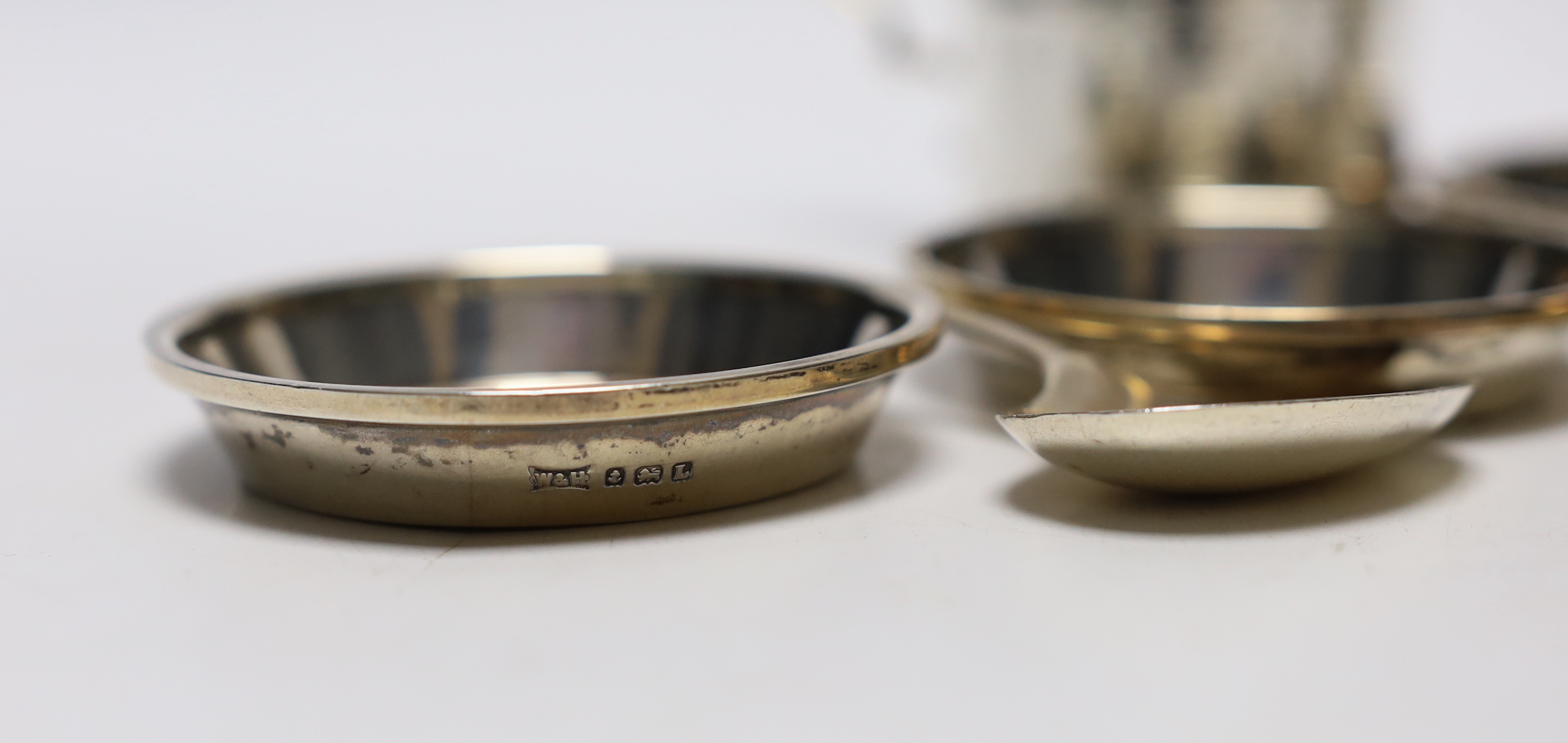 A Victorian silver mustard pot, Martin, Hall & Co, Sheffield, 1885, a set of four small silver dishes by Walker & Hall, a silver spoon & pusher and a silver napkin ring.